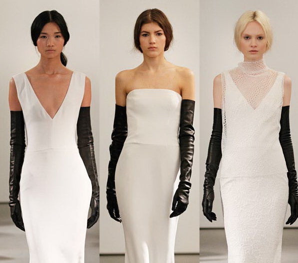 Three models are standing side by side, each wearing a long white dress. The first model's dress has a deep V-neck, the second model's dress is strapless, and the third model's dress has a high neck with a delicate sheer overlay. All models are wearing long black gloves and have their hair styled simply.