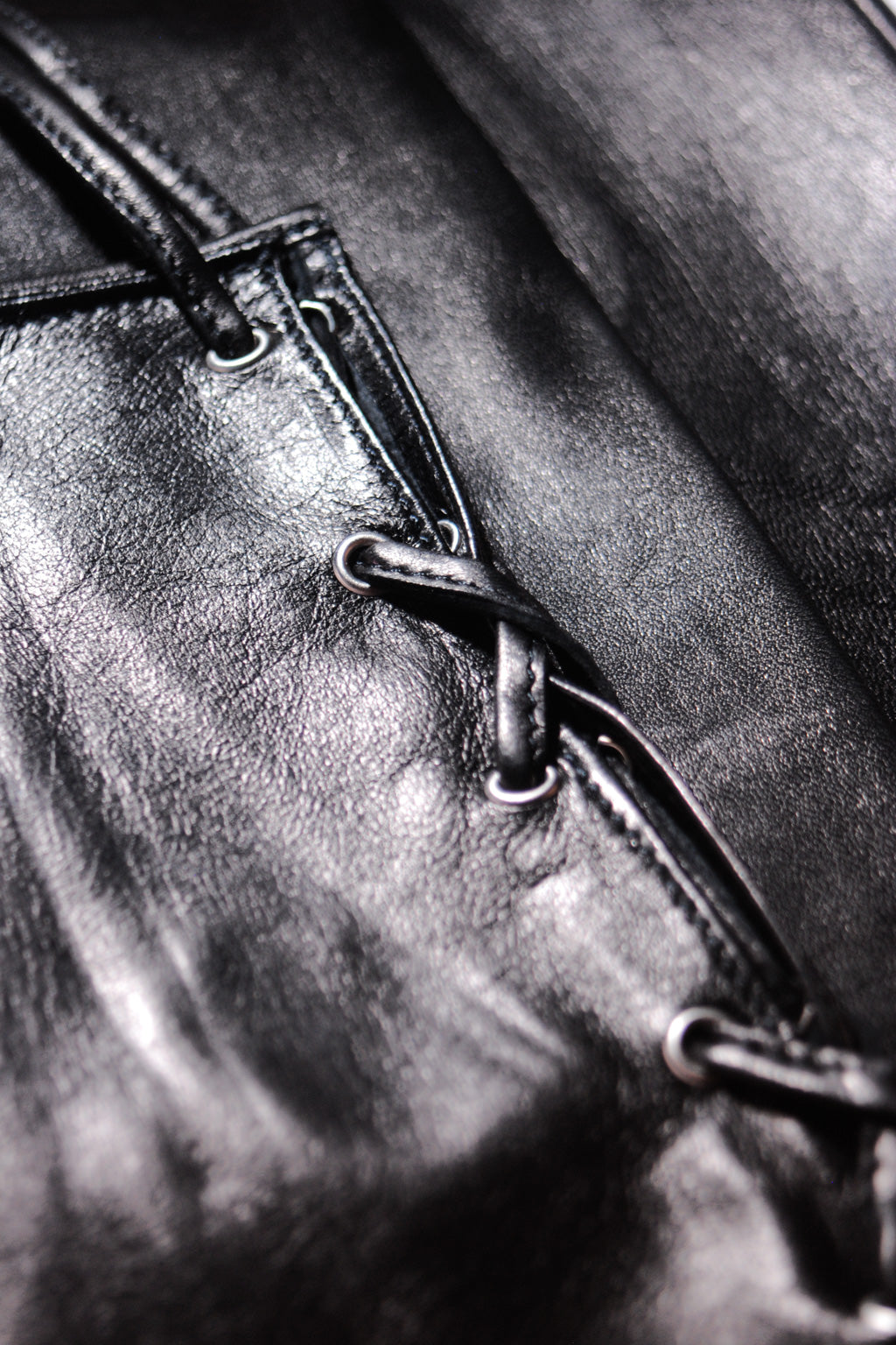 Detail of long leather gloves with corset closing by Ines
